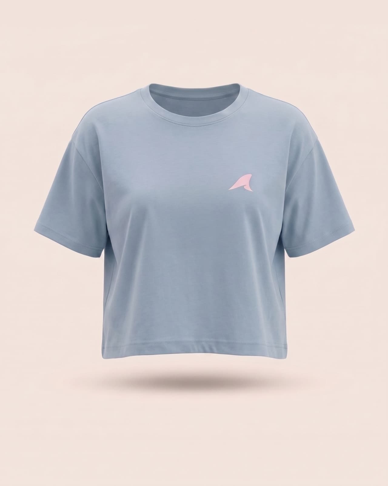 Coastal Crop Tee in blue, front view on a soft neutral background with the fin logo on the chest